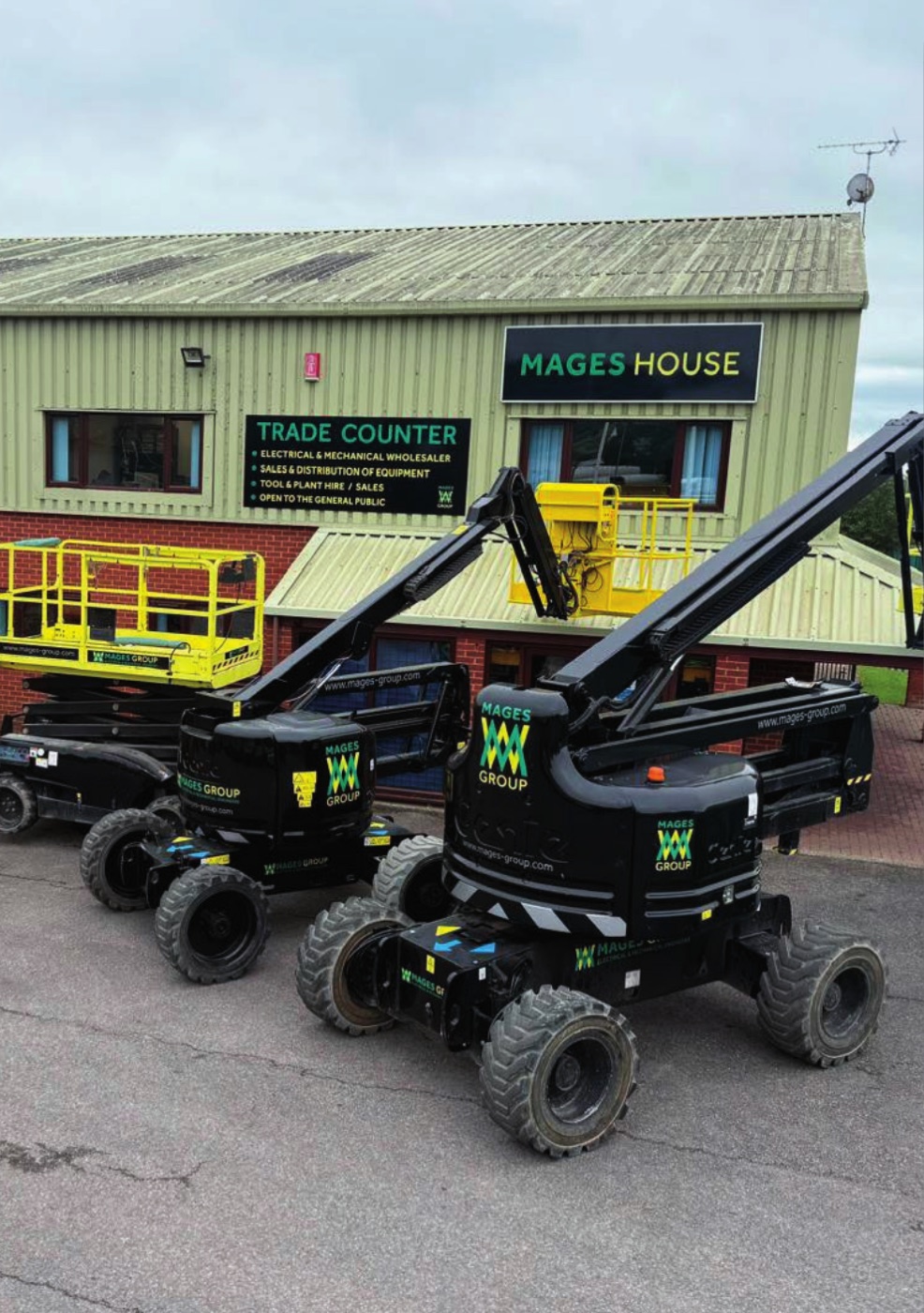 Mages House with Mages Group branded boom and scissor lifts parked outside